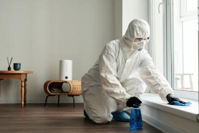 Cleaning,Worker,In,Protective,Suit,Disinfecting,Surface,With,Detergent,During